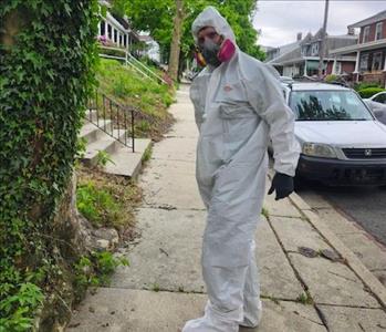 A Servpro employee in a hazmat suit.