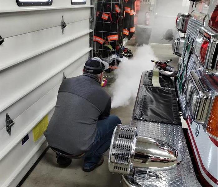 A SERVPRO employee is doing odor removal at a local fire station.